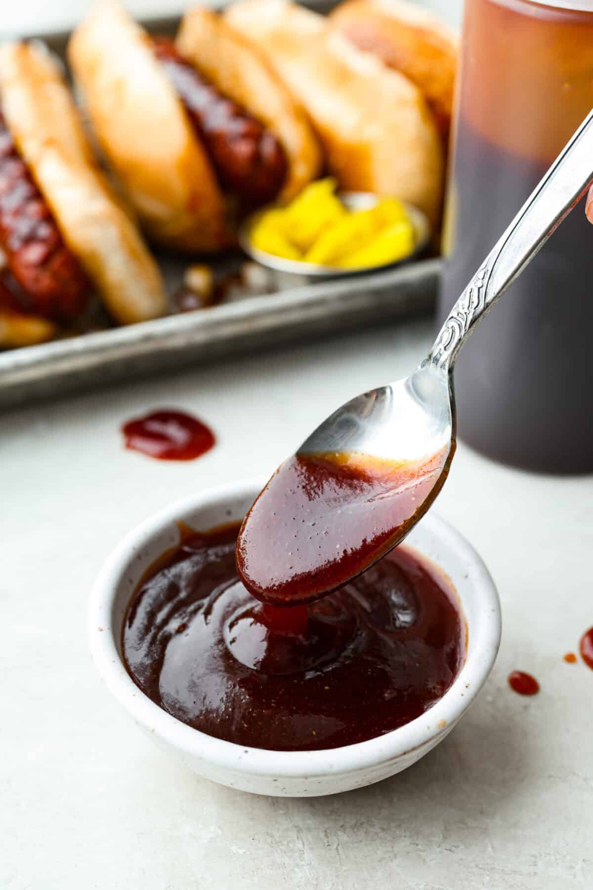 Here in Utah, J. Dawgs is basically a religion! Their hot dogs are THAT good. The sweet, tangy, smoky sauce? Life-changing! Make this copycat J Dawgs sauce at home and you’ll never look at ketchup the same way again. Small bowl of J Dawgs sauce with a spoon.